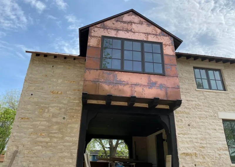 Copper metal panel facade on a stone building for Skylight Installation in Mammoth Lakes